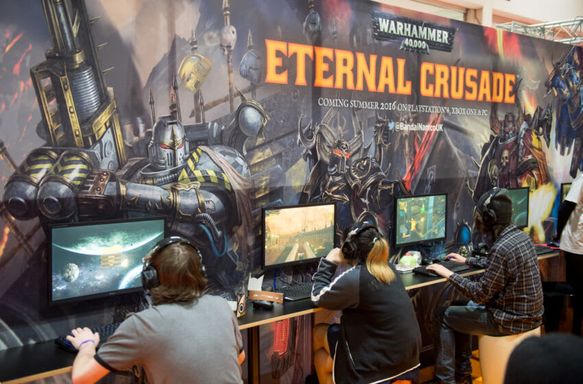 LONDON, ENGLAND - MAY 27: Video game fans playing the Games Workshop Warhammer 40,000 game Eternal Crusade ahead of its summer release on Day 1 of MCM London Comic Con at The London ExCel on May 27, 2016 in London, England. (Photo by Ollie Millington/WireImage)